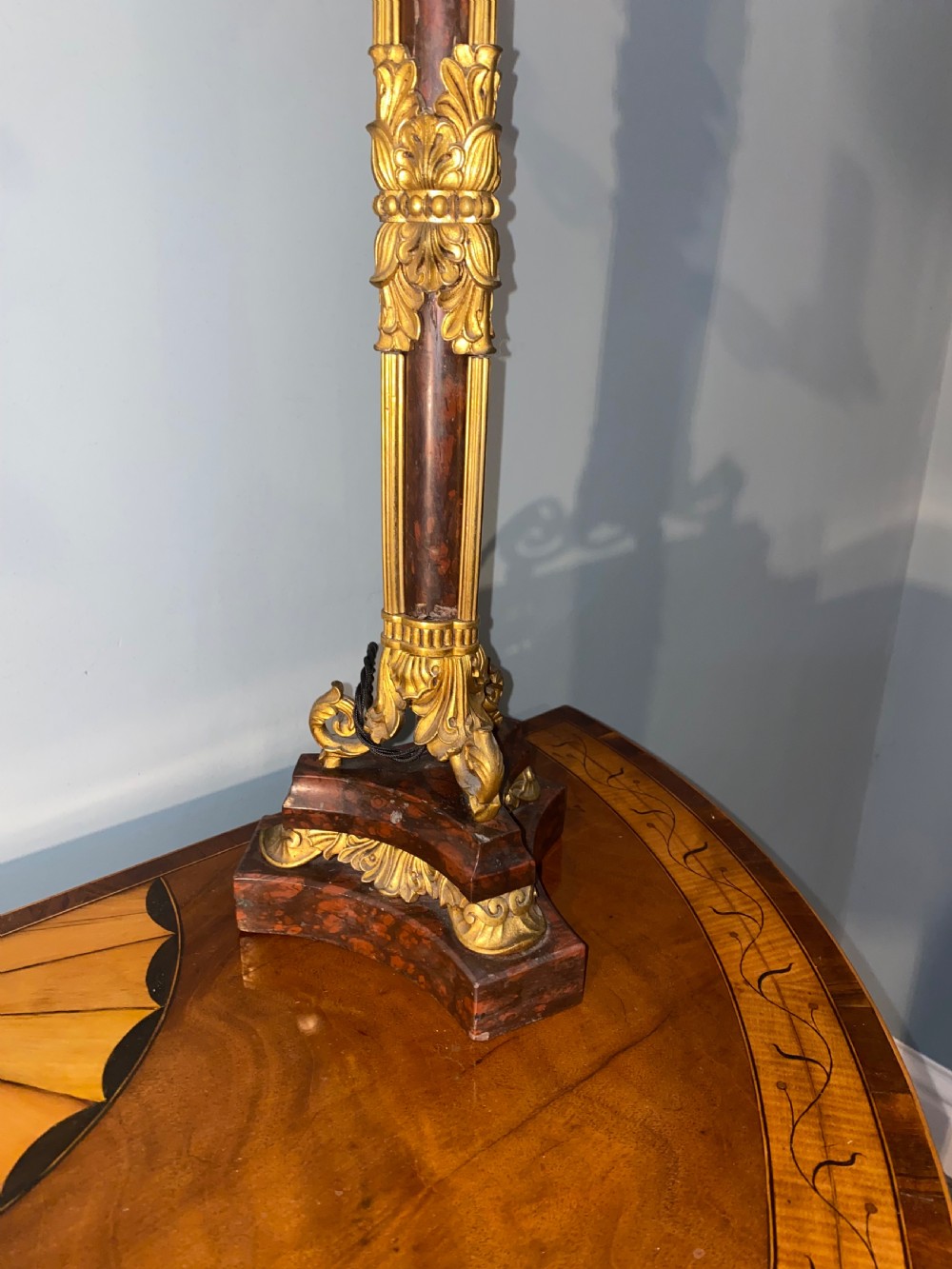 A pair of Neoclassical style gilt bronze and red marble candelabra table lamps featuring scroll arms and candle sockets. View V