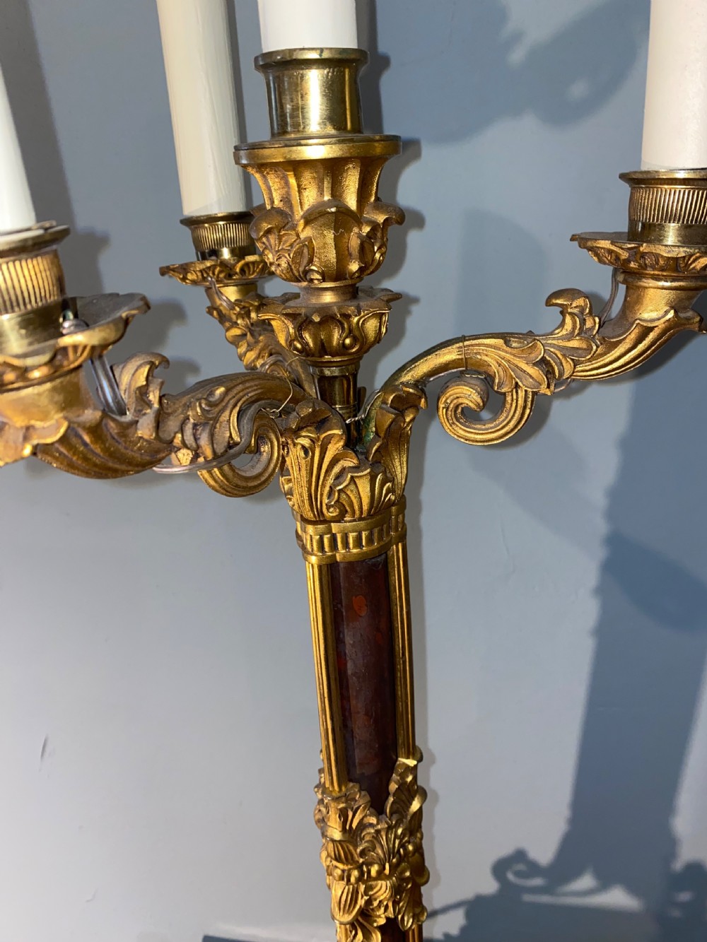 A pair of Neoclassical style gilt bronze and red marble candelabra table lamps featuring scroll arms and candle sockets. View VI