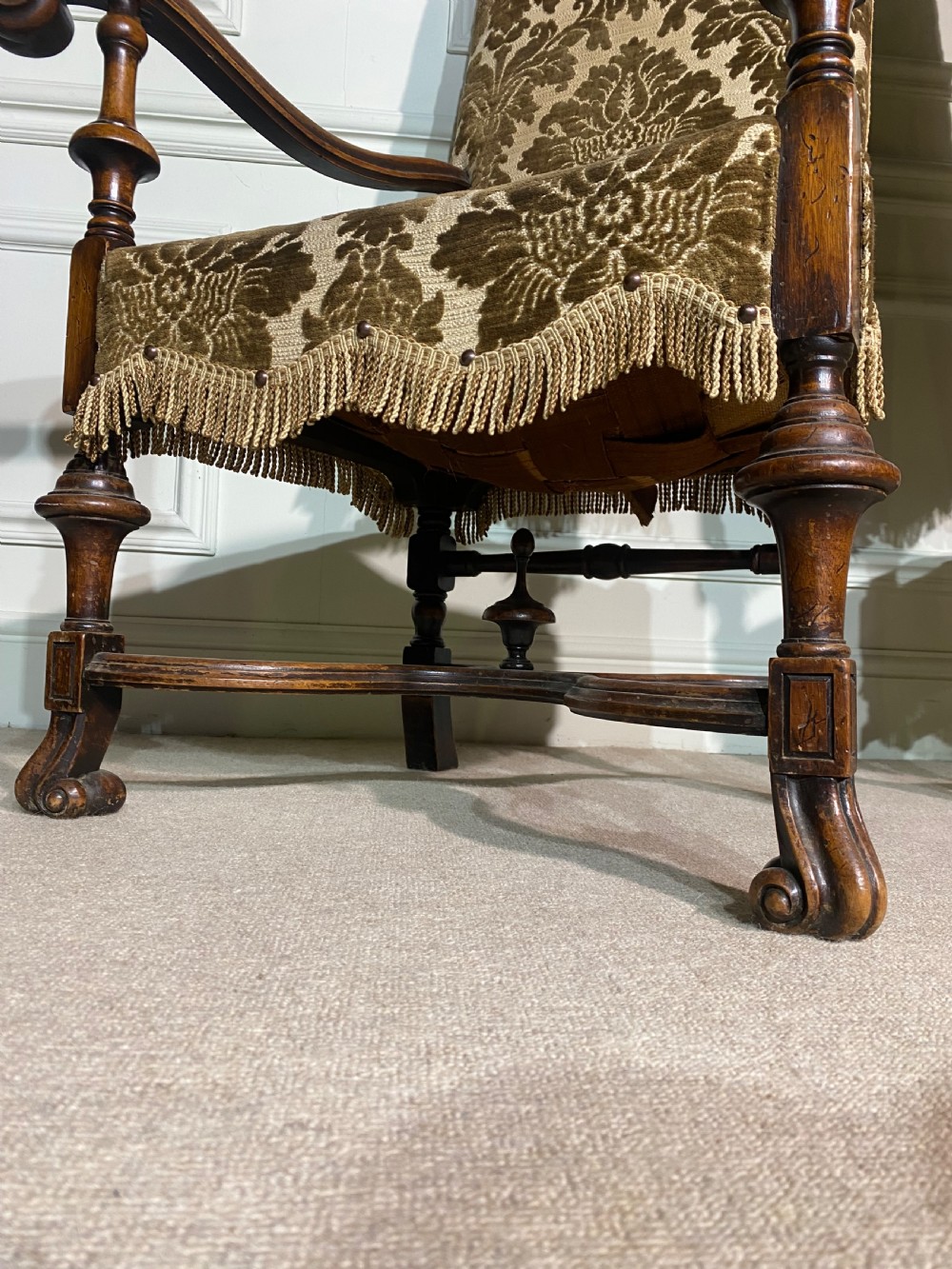 A pair of high-back Carolean style armchairs upholstered in patterned brown velvet with fringe trim and carved timber frames. View IX