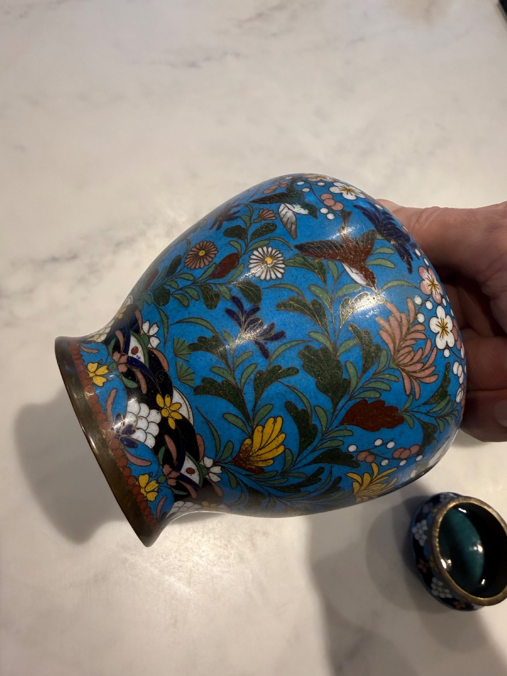 A pair of bulbous Japanese cloisonne ginger jars with lids, featuring intricate floral and bird motifs on a vibrant turquoise blue ground. View IV