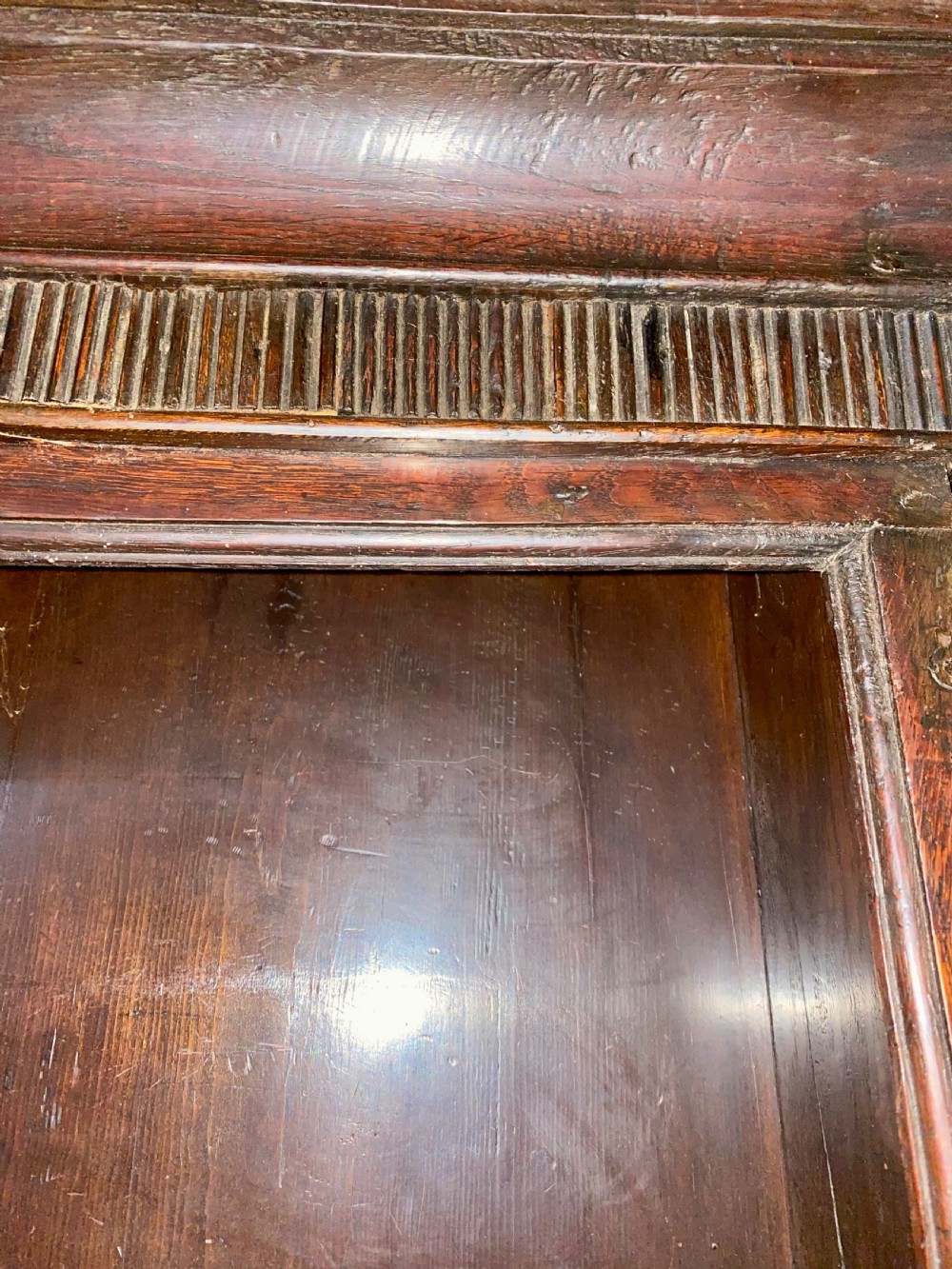 A Georgian oak dresser featuring a tall open plate rack top above five base drawers, turned legs, brass handles, and a lower pot board. View III