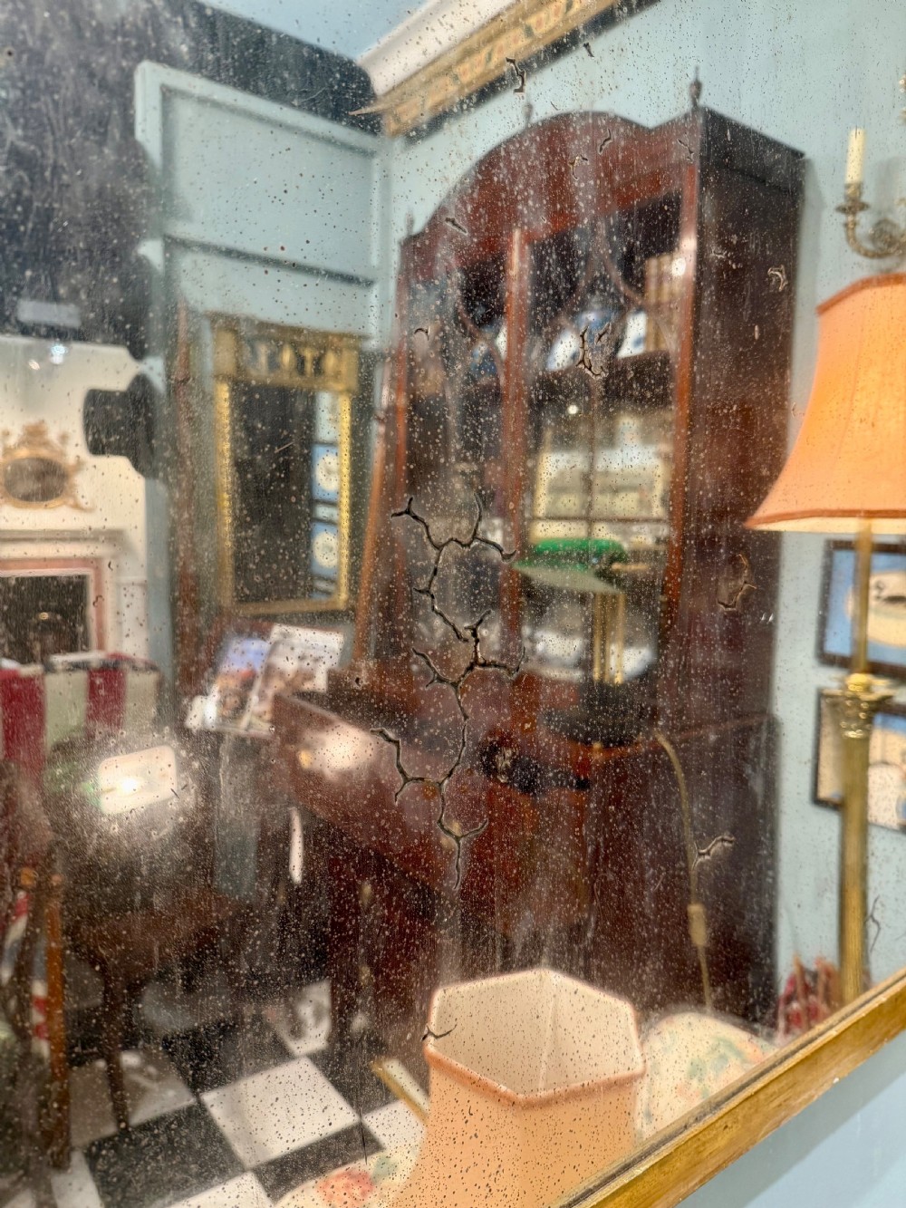 A large rectangular Regency giltwood overmantel mirror featuring architectural fluted pilasters, corner rosettes, and floral moulding along the top frame. View II