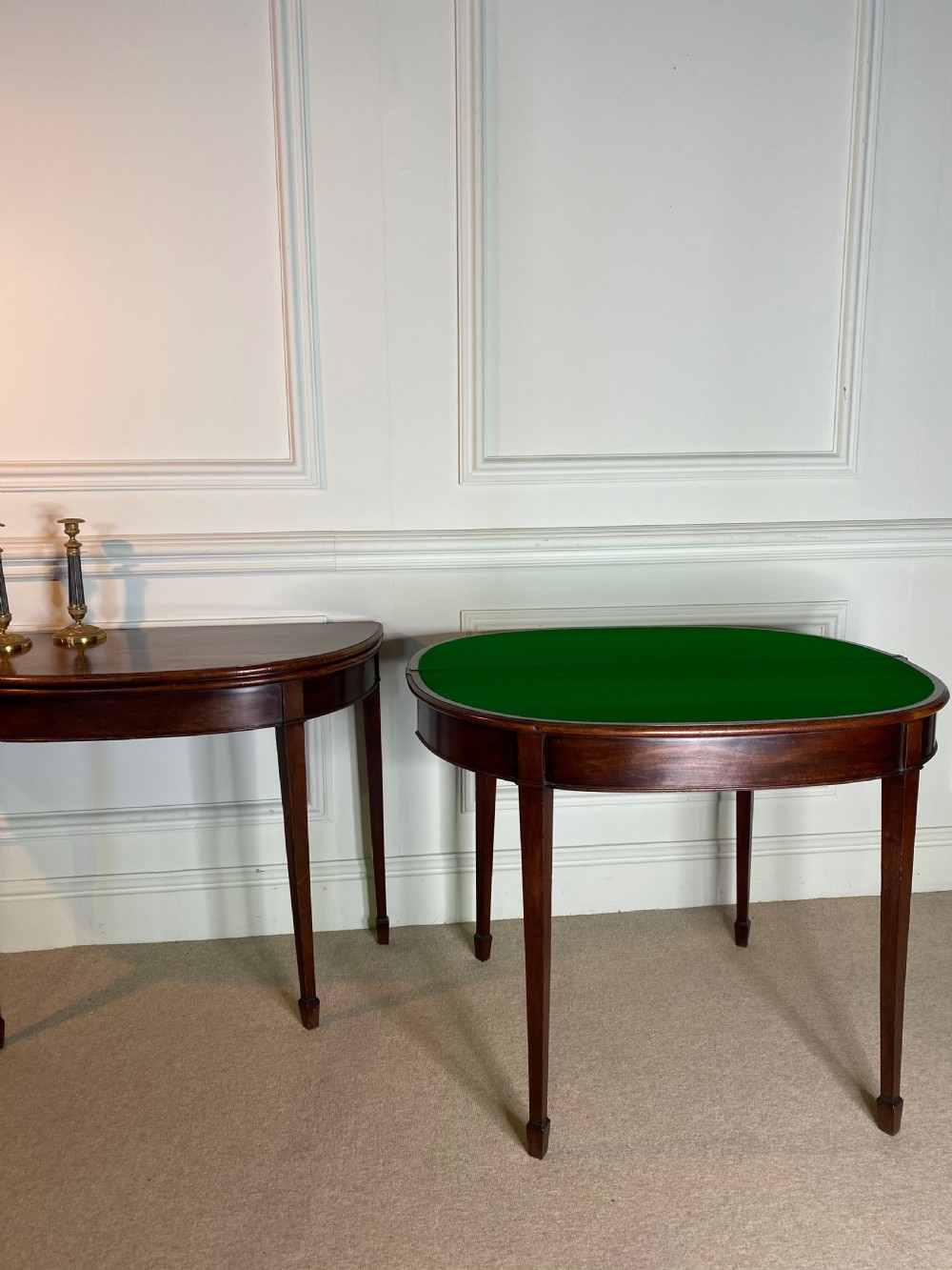 A pair of late eighteenth-century Georgian mahogany demilune card tables with fold-over tops and square tapered legs. View III