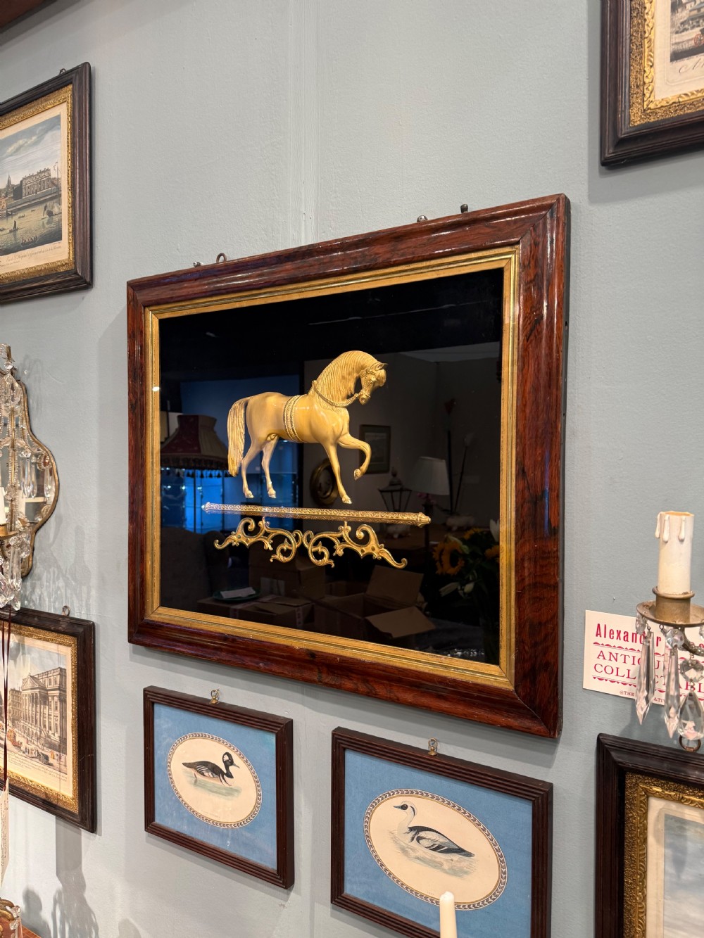 A 19th-century gilt bronze relief sculpture of a horse mounted on a dark background within a rosewood frame with gold slip. View II