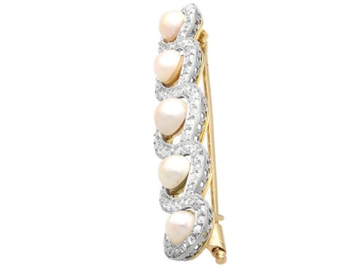 fig 2. An Art Deco gold bar brooch featuring five natural pearls framed within a diamond-set intertwined ribbon setting.