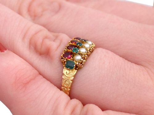 fig 7. A Victorian 15ct yellow gold dress ring set with multiple rows of emeralds, amethysts, and pearls featuring carved shoulders.