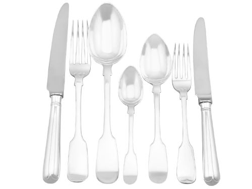 fig 1. An antique Victorian sterling silver cutlery set in the Fiddle pattern, featuring knives, forks, spoons, and ladles arranged on a plain white background.