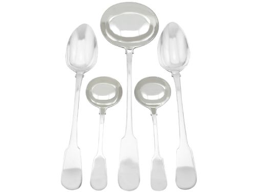 fig 2. An antique Victorian sterling silver cutlery set in the Fiddle pattern, featuring knives, forks, spoons, and ladles arranged on a plain white background.