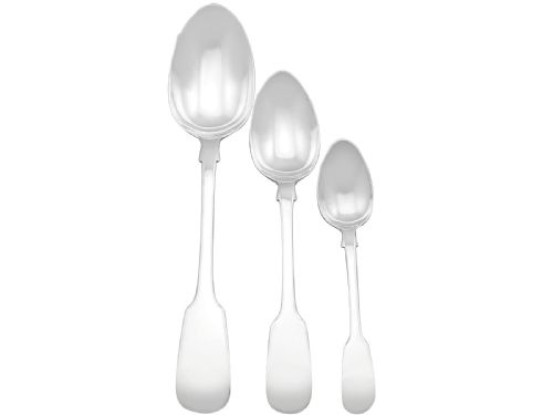 fig 4. An antique Victorian sterling silver cutlery set in the Fiddle pattern, featuring knives, forks, spoons, and ladles arranged on a plain white background.