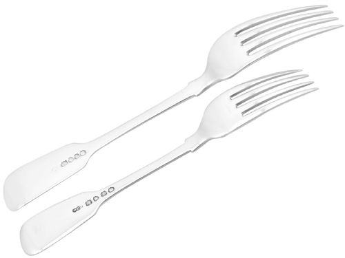 fig 8. An antique Victorian sterling silver cutlery set in the Fiddle pattern, featuring knives, forks, spoons, and ladles arranged on a plain white background.