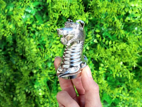 fig 1. A pair of antique Victorian sterling silver pepper casters sculpted in the form of detailed dragon heads.