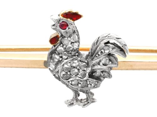 fig 2. An antique 14ct yellow gold bar brooch adorned with a silver-set diamond cockerel motif featuring a ruby eye and red enamelled details.
