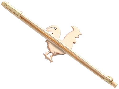 fig 4. An antique 14ct yellow gold bar brooch adorned with a silver-set diamond cockerel motif featuring a ruby eye and red enamelled details.