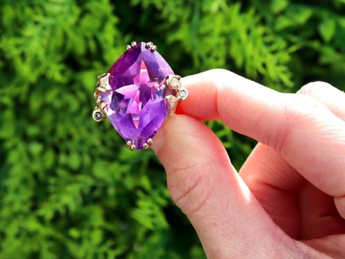 fig 1. A vintage 14ct yellow gold dress ring featuring a large faceted purple amethyst with textured claw settings and small diamond accents.