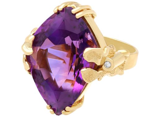 fig 5. A vintage 14ct yellow gold dress ring featuring a large faceted purple amethyst with textured claw settings and small diamond accents.