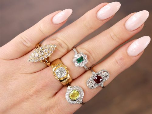 fig 2. An antique 18ct yellow gold solitaire ring featuring a broad band and a cushion cut diamond set in a scalloped collet.