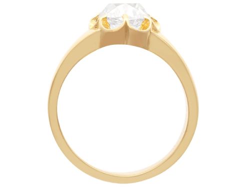 fig 6. An antique 18ct yellow gold solitaire ring featuring a broad band and a cushion cut diamond set in a scalloped collet.