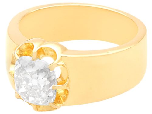 fig 4. An antique 18ct yellow gold solitaire ring featuring a broad band and a cushion cut diamond set in a scalloped collet.