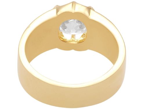 fig 5. An antique 18ct yellow gold solitaire ring featuring a broad band and a cushion cut diamond set in a scalloped collet.