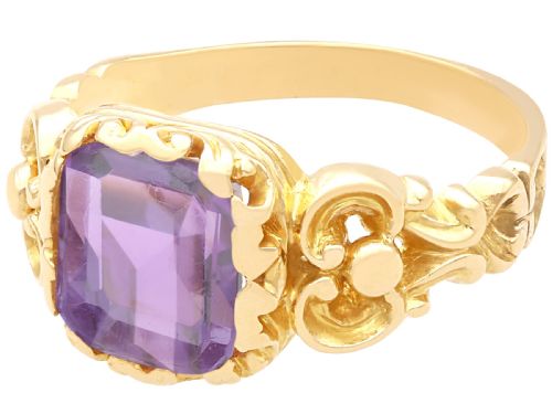 fig 2. An antique 15ct yellow gold ring featuring an emerald-cut purple amethyst gemstone with detailed scrollwork on the shoulders.