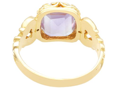 fig 3. An antique 15ct yellow gold ring featuring an emerald-cut purple amethyst gemstone with detailed scrollwork on the shoulders.