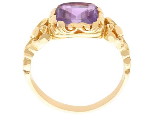 fig 4. An antique 15ct yellow gold ring featuring an emerald-cut purple amethyst gemstone with detailed scrollwork on the shoulders.