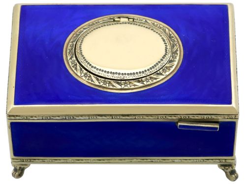 fig 3. A rectangular cobalt blue guilloche enamel and silver-gilt singing bird box with an engraved oval hatch cover and tiny cabriole feet.