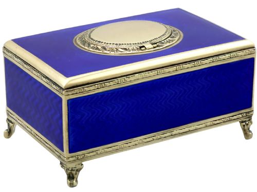 fig 4. A rectangular cobalt blue guilloche enamel and silver-gilt singing bird box with an engraved oval hatch cover and tiny cabriole feet.