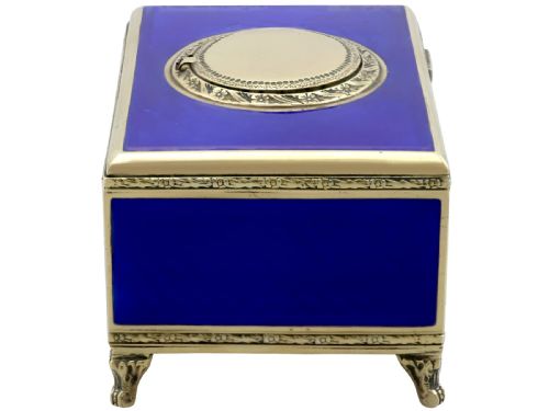 fig 5. A rectangular cobalt blue guilloche enamel and silver-gilt singing bird box with an engraved oval hatch cover and tiny cabriole feet.