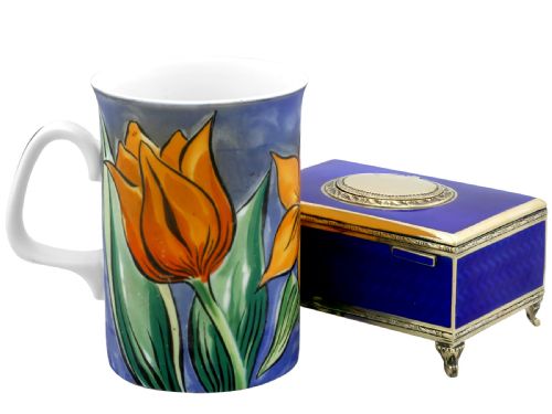 fig 6. A rectangular cobalt blue guilloche enamel and silver-gilt singing bird box with an engraved oval hatch cover and tiny cabriole feet.