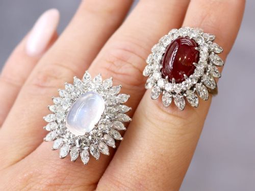fig 2. A vintage 18ct yellow gold ring featuring a central oval cabochon red ruby surrounded by a double tiered cluster halo of diamonds.