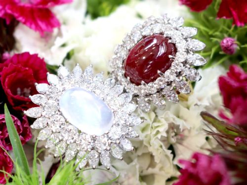 fig 3. A vintage 18ct yellow gold ring featuring a central oval cabochon red ruby surrounded by a double tiered cluster halo of diamonds.