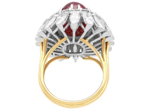 fig 5. A vintage 18ct yellow gold ring featuring a central oval cabochon red ruby surrounded by a double tiered cluster halo of diamonds.