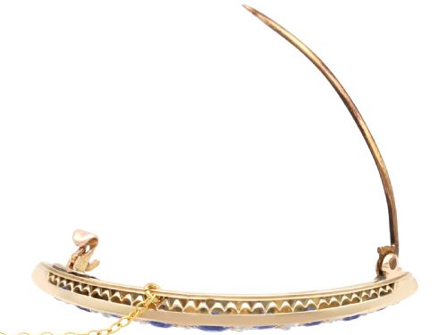 fig 5. A crescent moon brooch set with graduated blue sapphires and accent diamonds in nine-carat yellow gold with an attached safety chain.