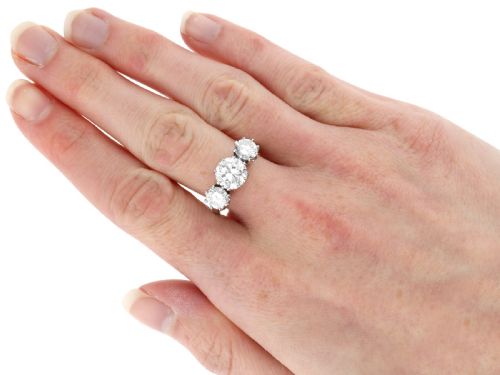 fig 7. A platinum trilogy ring featuring three round brilliant cut diamonds set in individual multi-claw settings along a polished platinum band.