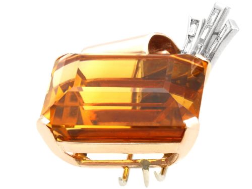 fig 4. A large emerald-cut amber citrine stone set in a 14ct yellow gold brooch mounting accented with baguette diamonds.