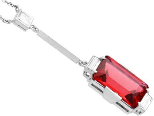 fig 3. An Art Deco 18ct white gold pendant featuring a rectangular step-cut red tourmaline suspended from a bar link set with accent diamonds.