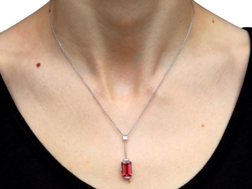 fig 7. An Art Deco 18ct white gold pendant featuring a rectangular step-cut red tourmaline suspended from a bar link set with accent diamonds.