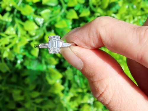 fig 1. An Art Deco 14ct white gold solitaire ring featuring a central emerald-cut diamond flanked by tapered baguette diamond shoulders.