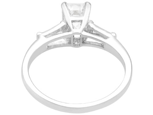 fig 3. An Art Deco 14ct white gold solitaire ring featuring a central emerald-cut diamond flanked by tapered baguette diamond shoulders.