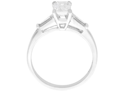 fig 4. An Art Deco 14ct white gold solitaire ring featuring a central emerald-cut diamond flanked by tapered baguette diamond shoulders.