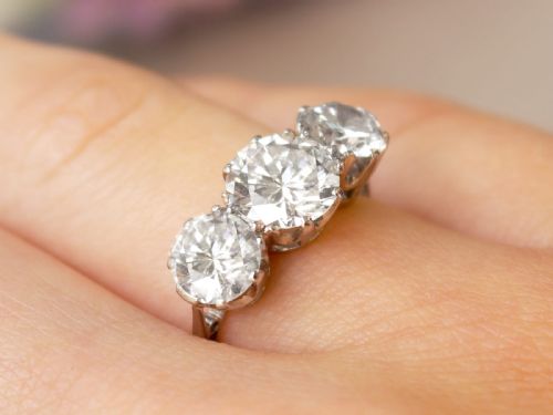 fig 2. A vintage platinum ring featuring three large round brilliant cut diamonds set horizontally in claw settings.