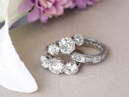 fig 3. A vintage platinum ring featuring three large round brilliant cut diamonds set horizontally in claw settings.