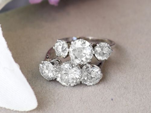 fig 4. A vintage platinum ring featuring three large round brilliant cut diamonds set horizontally in claw settings.