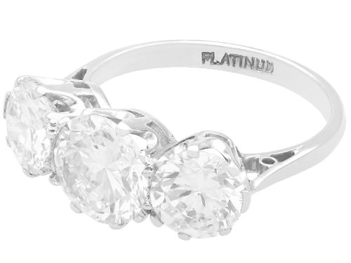 fig 5. A vintage platinum ring featuring three large round brilliant cut diamonds set horizontally in claw settings.