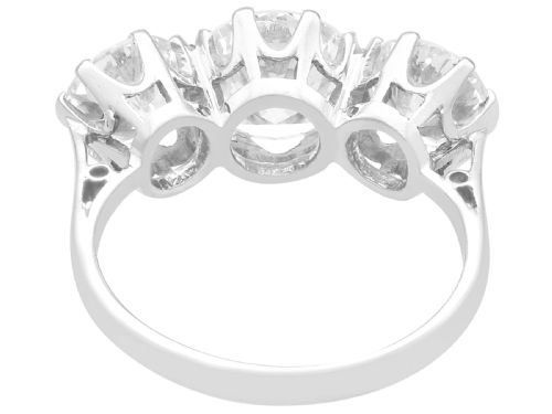 fig 6. A vintage platinum ring featuring three large round brilliant cut diamonds set horizontally in claw settings.