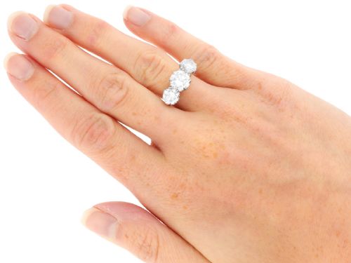 fig 8. A vintage platinum ring featuring three large round brilliant cut diamonds set horizontally in claw settings.