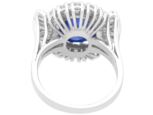 fig 5. A vintage 18ct white gold cluster ring featuring a central oval cabochon blue sapphire framed by brilliant-cut and baguette-cut diamonds.