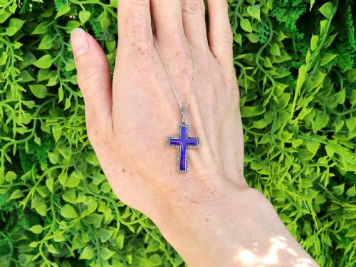 fig 1. An antique Victorian cross pendant featuring cobalt blue enamel framed by small diamonds set in metal atop a 15ct yellow gold backing.