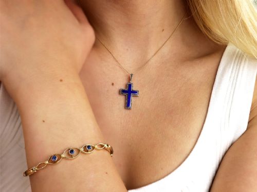 fig 2. An antique Victorian cross pendant featuring cobalt blue enamel framed by small diamonds set in metal atop a 15ct yellow gold backing.